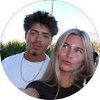 Young man with a goatee and blonde woman making a playful face in a selfie.